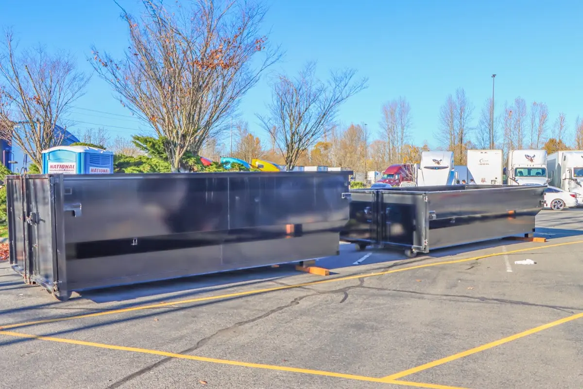 Professional dumpster rental service with roll-off container on residential driveway in Conshohocken